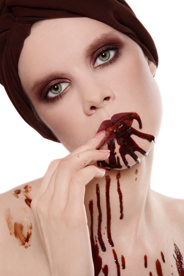 Portrait of woman with beautiful stylish makeup and chocolate on her face. Portrait of woman with beautiful stylish makeup and chocolate on her face