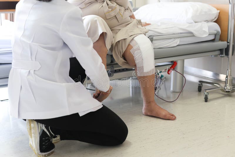 Doctor doing Physical therapy for Patient with a knee injury in hospital. Doctor doing Physical therapy for Patient with a knee injury in hospital