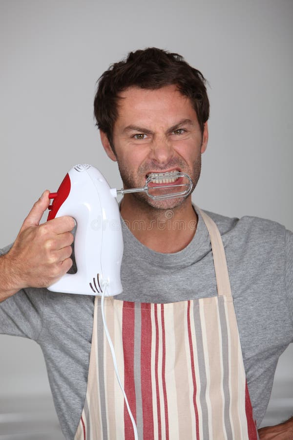 Aggressive chef wielding an electric hand mixer. Aggressive chef wielding an electric hand mixer