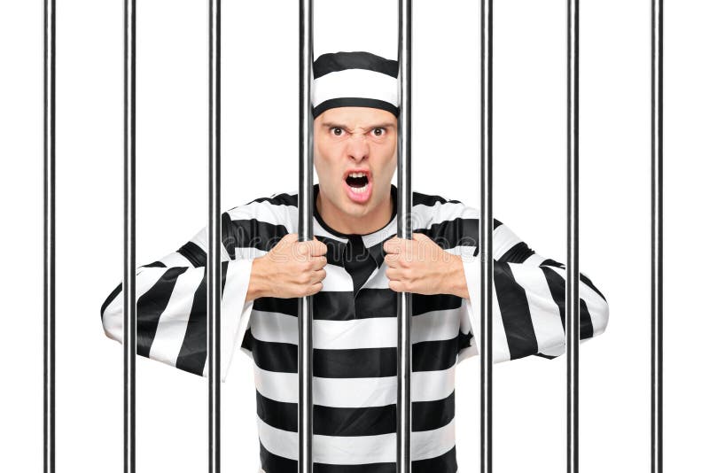 An agitated prisoner in jail holding bars. 