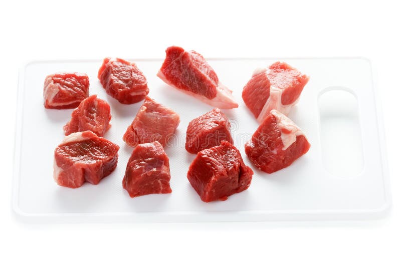 Raw lamb meat cut in cubes on a white background. Raw lamb meat cut in cubes on a white background