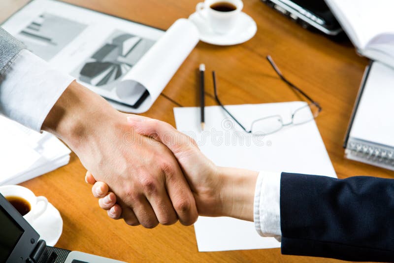 Business people�s handshake over table with business objects on it. Negotiating table stock images, royalty-free photos and pictures