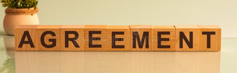AGREEMENT word on wooden cubes on yellow background stock photography