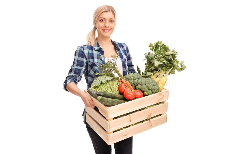 Female agricultural worker carrying a wooden crate full of fresh vegetables isolated on white background. Female agricultural worker carrying a wooden crate full of fresh vegetables isolated on white background