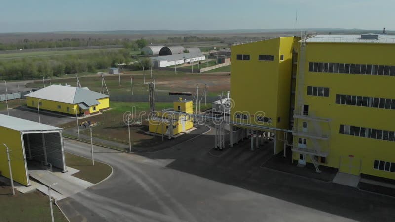 Agricultural granary for storage in tanks. Production facilities at the plant. Yellow buildings and grain elevators