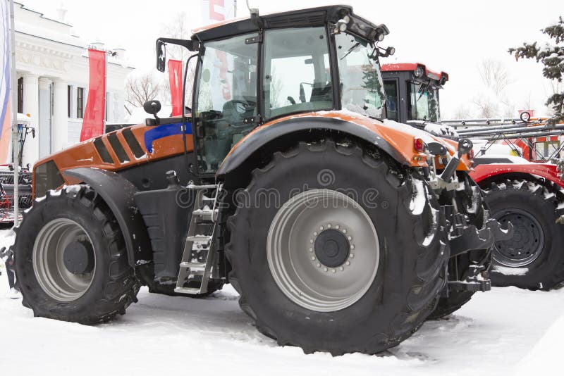 Agricultural tractor at winter snow day