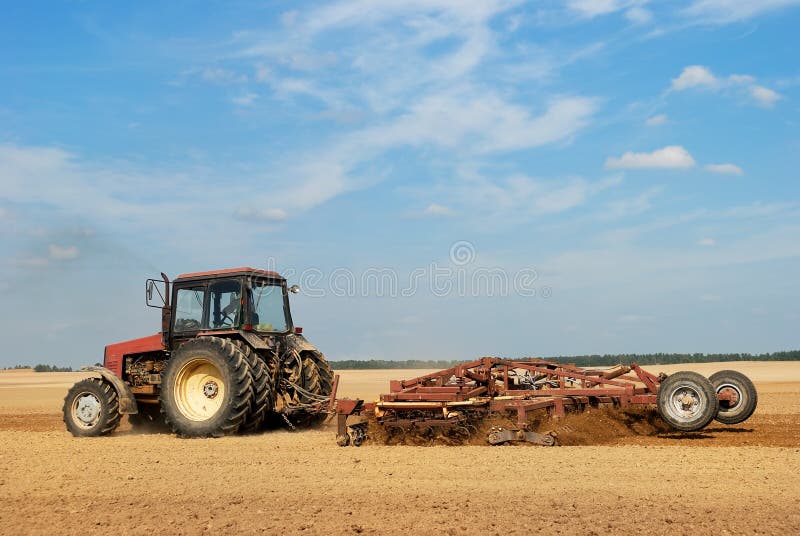 Agriculture ploughing tractor outdoors stock photos