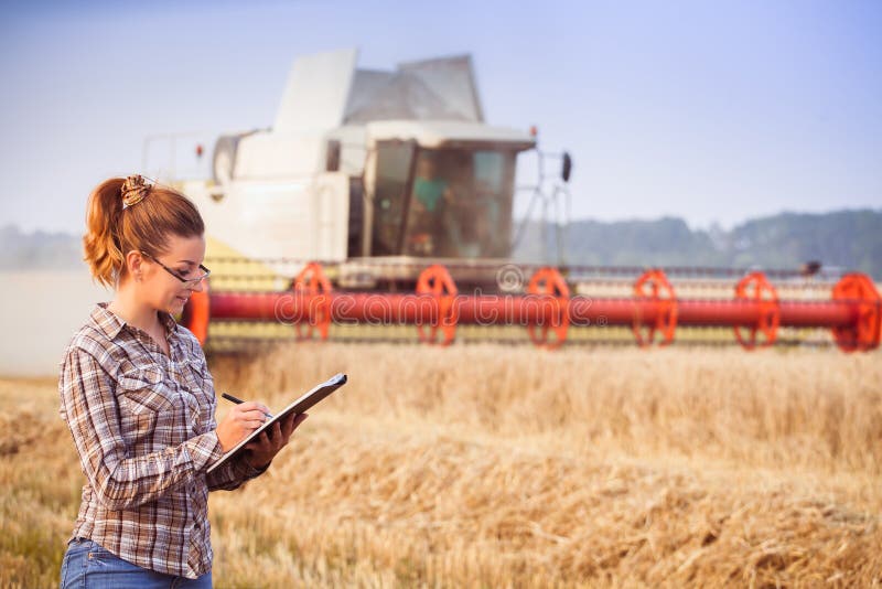 Agronomist girl in glasses keeps a crop accounting in the folder stock images Agronomist girl in glasses keeps a crop accounting in the folder stock images
