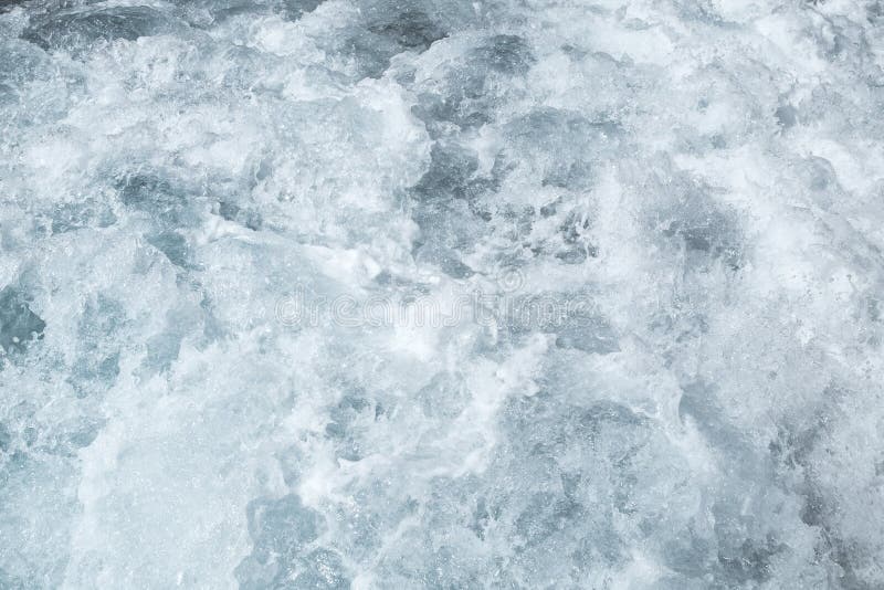 Agua superficial del mar agitado, superficie azul del agua de la textura de la espuma de la onda del mar detrás del barco de moto foto de archivo Agua superficial del mar agitado, superficie azul del agua de la textura de la espuma de la onda del mar detrás del barco de moto foto de archivo