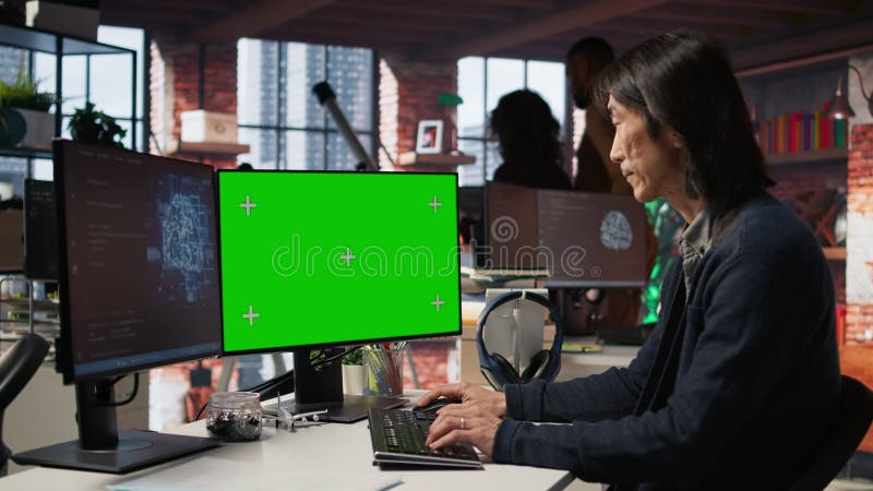AI startup office senior developer building application on green screen computer stock footage