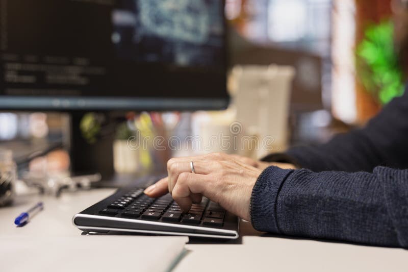 AI startup office software developer typing on computer keyboard, close up royalty free stock image
