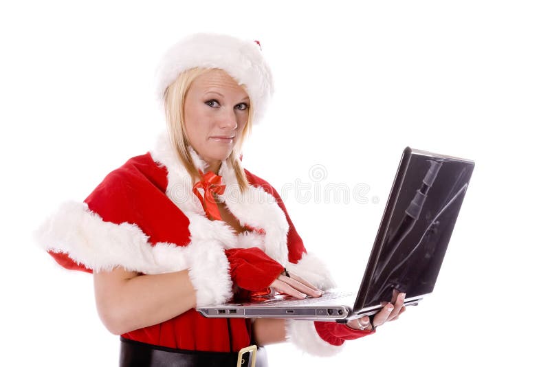 Aide de Santa effectuant la liste vilaine sur l'ordinateur photo stock Aide de Santa effectuant la liste vilaine sur l'ordinateur photo stock