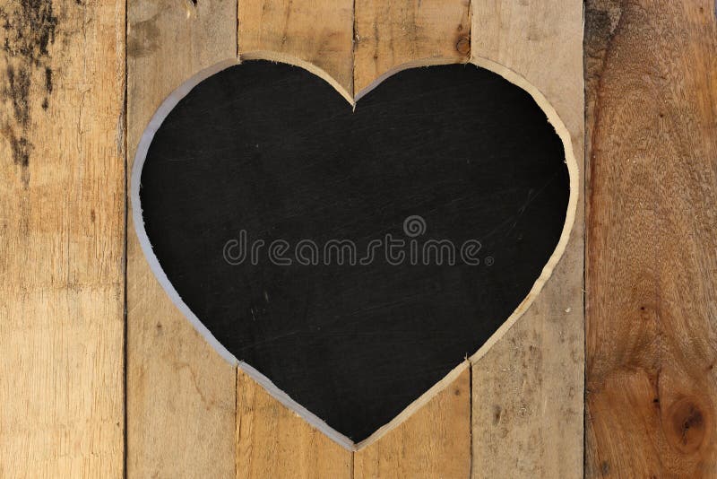 Love Valentines heart wooden frame from recycled old palette with black chalk board background, copy space. Love Valentines heart wooden frame from recycled old palette with black chalk board background, copy space