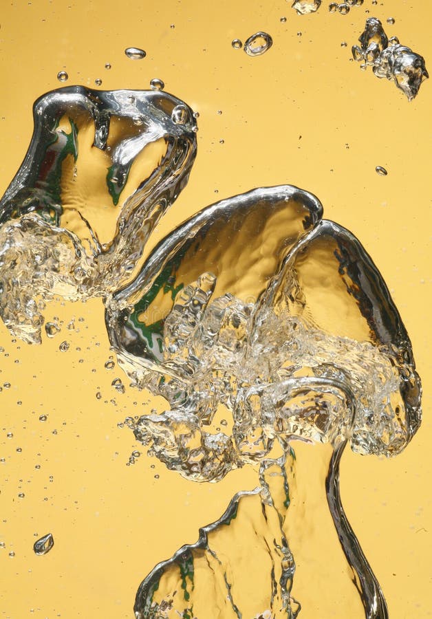 A closeup view of an explosion of air bubbles rising in clear water against an amber background. Clear closeup view stock images, royalty-free photos and pictures