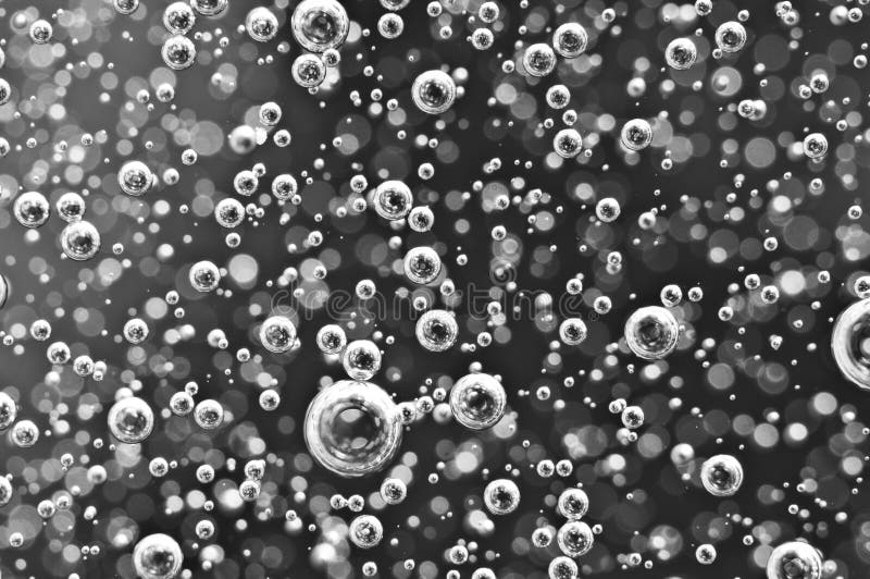 Air bubbles in water. Abstract black-and-white background. Macro