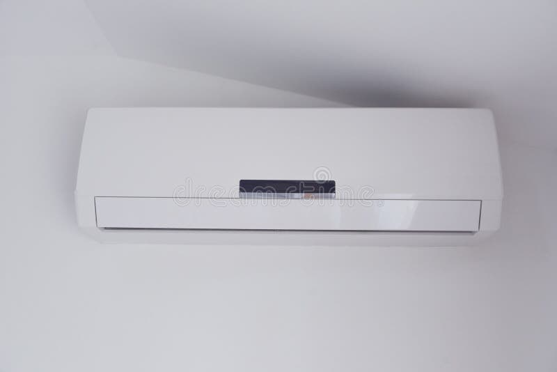 Air Conditioner Mounted on a White Wall of Apartment Bedroom Stock