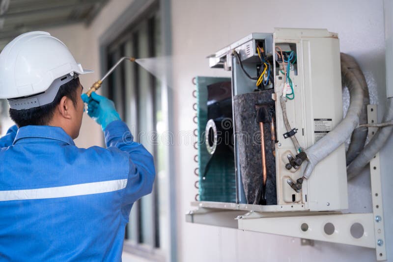 Air Conditioner Technician is Using a Highpressure Water Jet To Clean the Air Conditioner