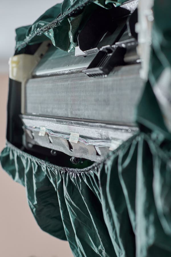 Air conditioner with waterproof drain cover for cleaning stock images