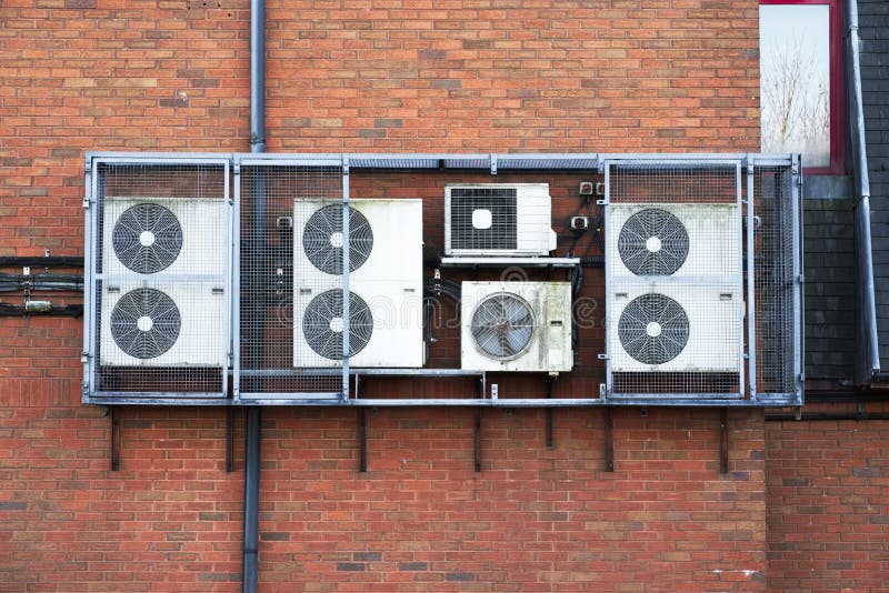 Air Conditioning Condensers in Cage Hanging on Wall Stock Photo Image