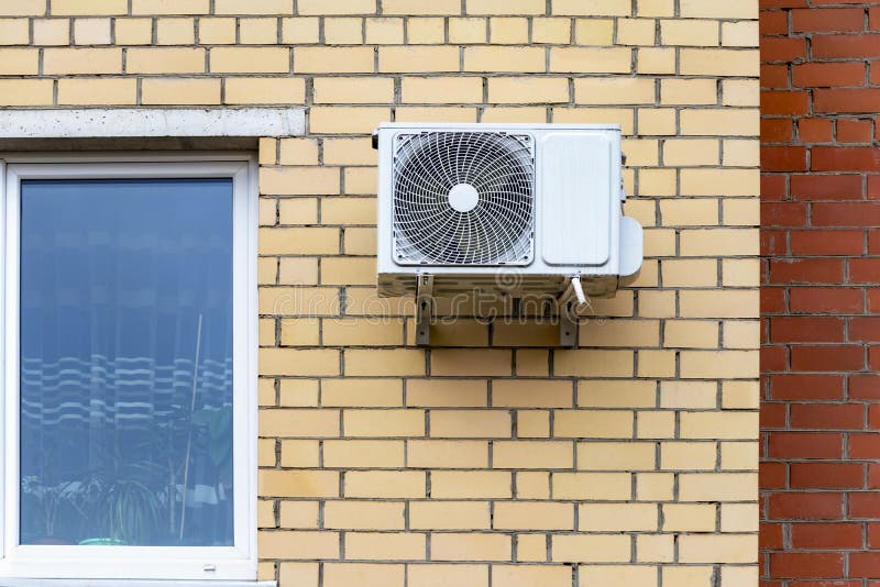 An Air Conditioning System Installed Outside on the Wall of a Brick