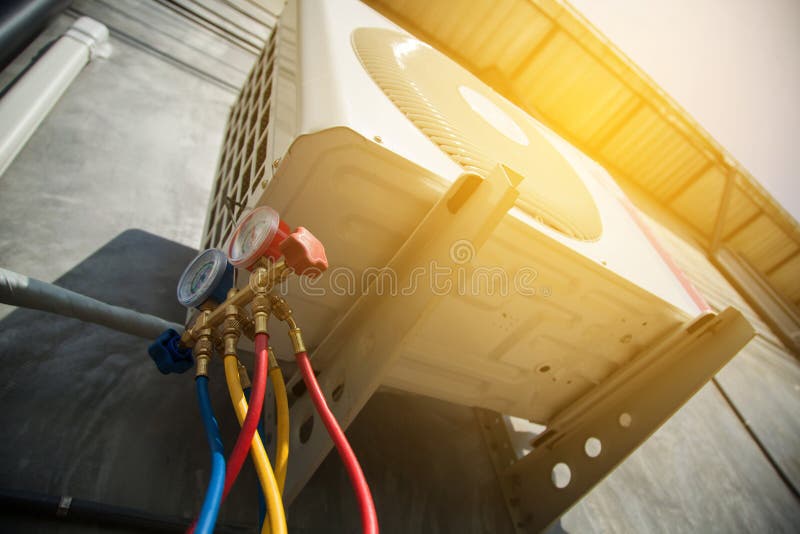 Air Conditioning Technician and A part of preparing to install new air conditioner. manometers measuring equipment for filling air conditioners,gauges. Metal n stock images, royalty-free photos and pictures