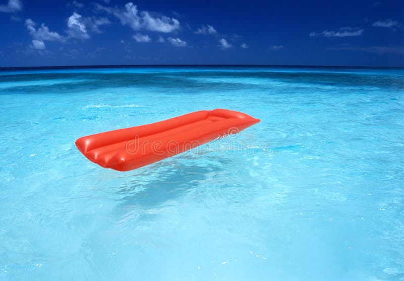 Air mattress in the ocean stock image. Image of blue 24548241