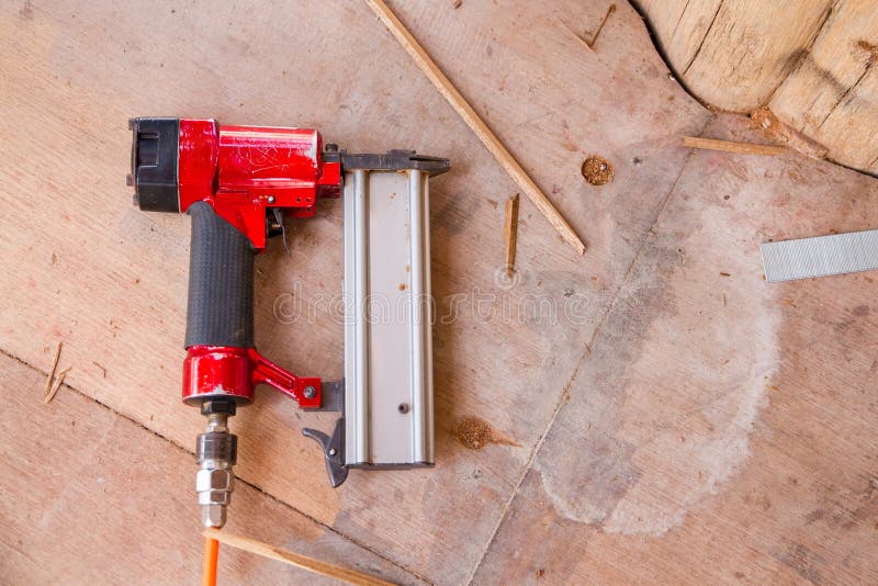 Air Nail Gun on the Wooden Floor Stock Image Image of carpenter, tool