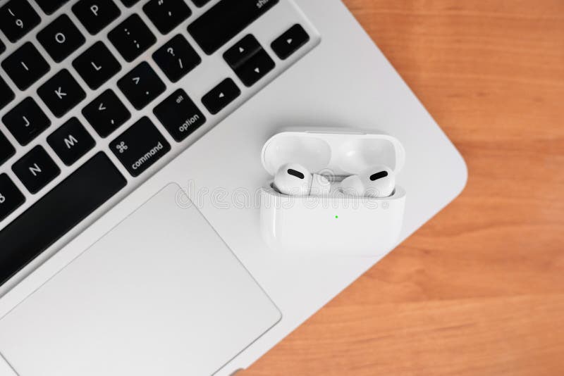 Air Pods Pro Macbook With Wireless Charging Case New Airpods Pro On Wooden Background Airpods Copy Space Editorial Image Image Of Hand Airpods