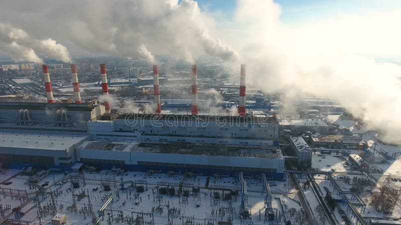 Air pollution concept. Power plant with smoke from chimneys. Drone shot.