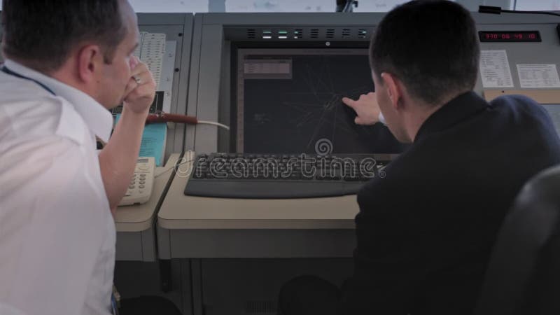 ASTANA, KAZAKHSTAN - JANUARY 7, 2018: air traffic controllers discuss the plan of movement of aircraft on a computer