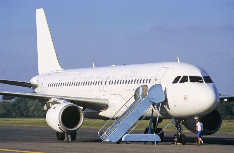 White Airbus plane waiting for passengers.