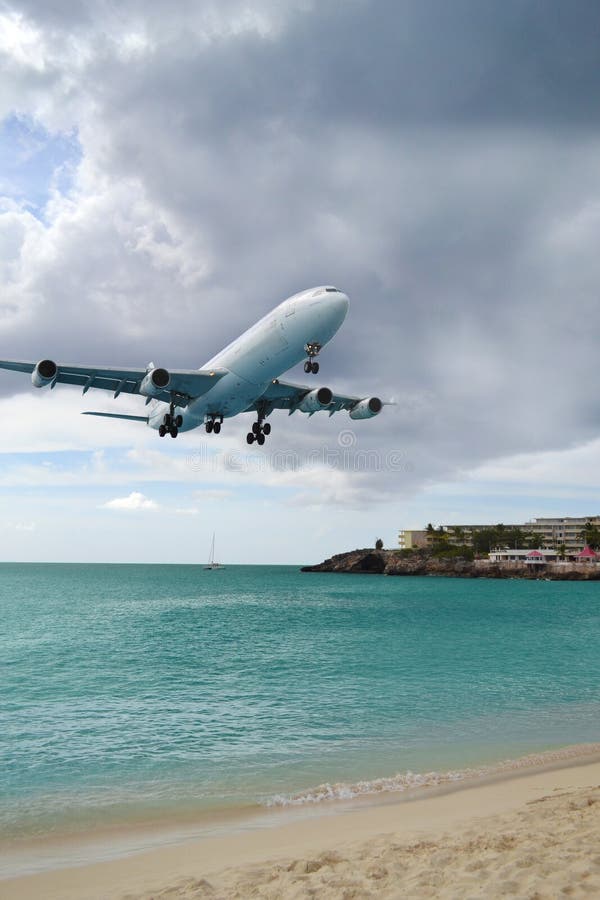Airplane Landing Over Busy Beach Editorial Image Image of landing