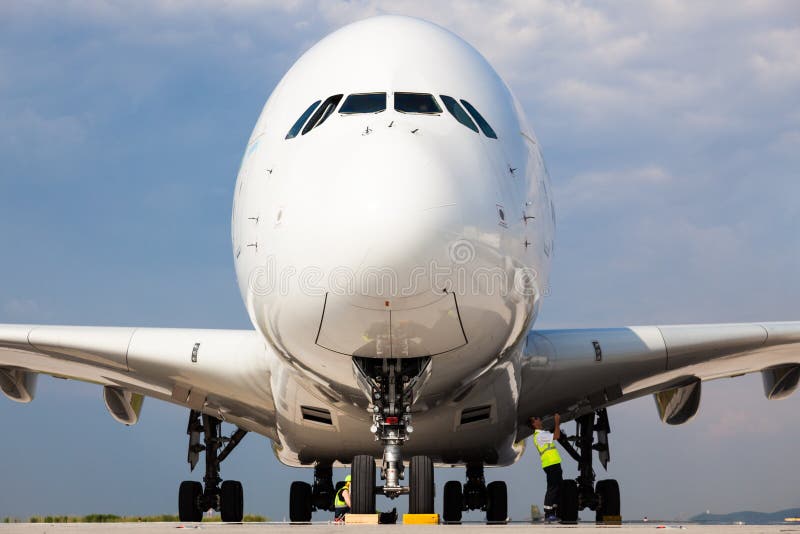 Airbus A380 Jumbo Jet take-off preparation by ground crew people at Berlin airport - low front nose view stock photography