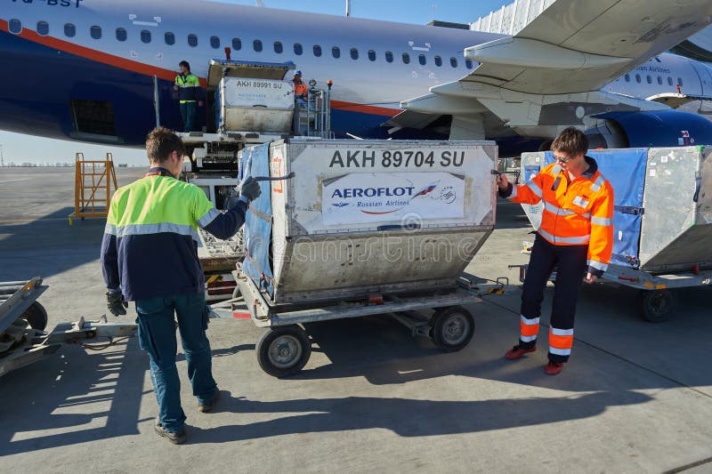 Aircraft of the Aeroflot Airbus VQ-BST during loading and unloading operations, preparing for the flight at the parking lot of royalty free stock photo