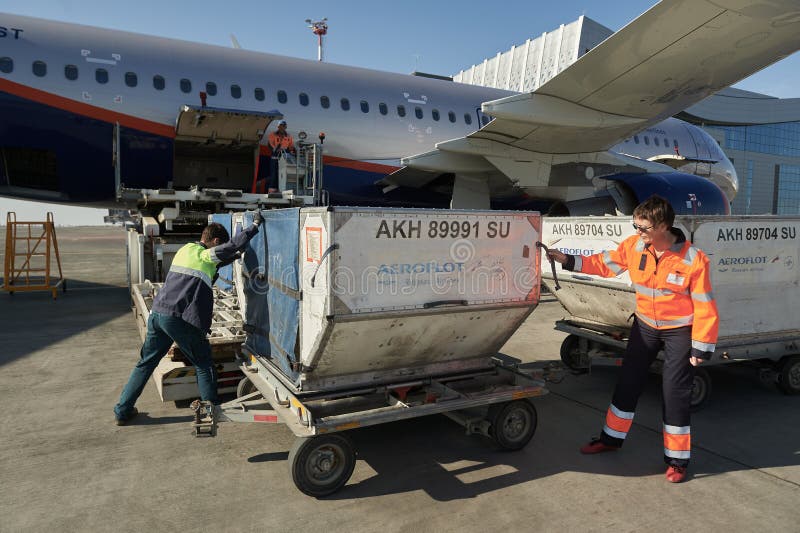Aircraft of the Aeroflot Airbus VQ-BST during loading and unloading operations, preparing for the flight at the parking lot of stock photography