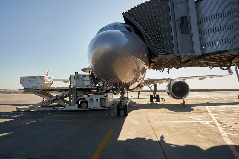 Aircraft of the Aeroflot Airbus VQ-BST during loading and unloading operations, preparing for the flight at the parking lot of stock photo