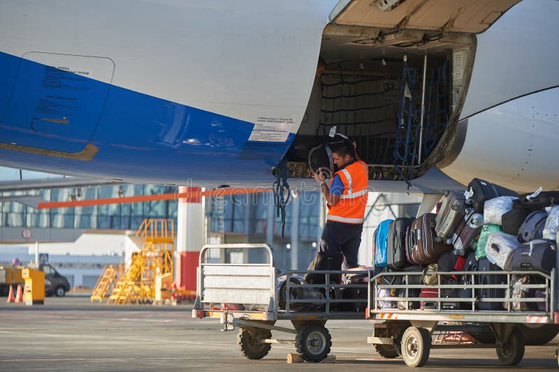 Aircraft of the Aeroflot Airbus VQ-BST during loading and unloading operations, preparing for the flight at the parking lot of royalty free stock photo