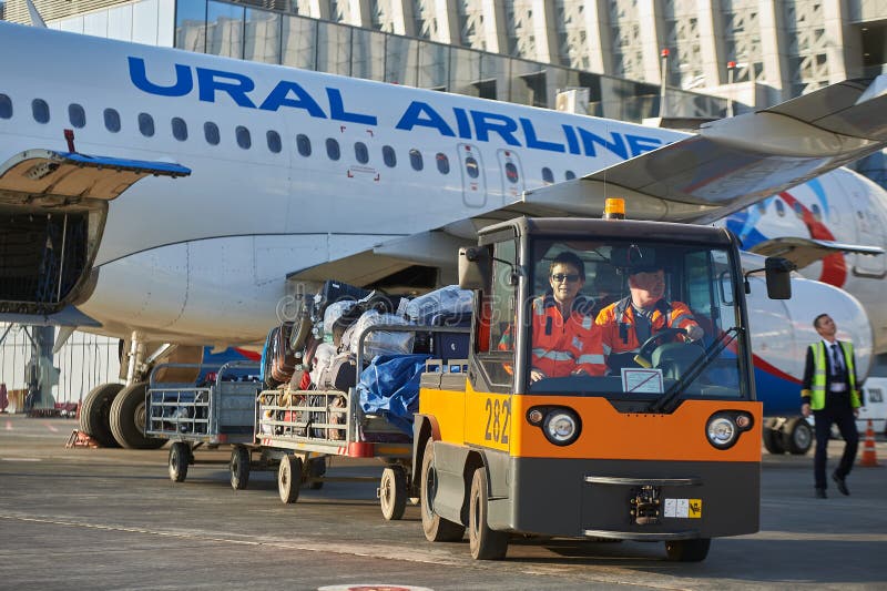 Aircraft of the Aeroflot Airbus VQ-BST during loading and unloading operations, preparing for the flight at the parking lot of stock photo