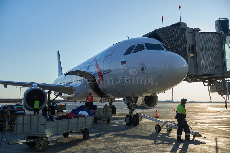 Aircraft of the Aeroflot Airbus VQ-BST during loading and unloading operations, preparing for the flight at the parking lot of stock photography