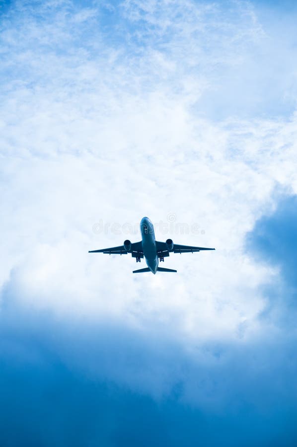 Aircraft in a clouded sky royalty free stock photo