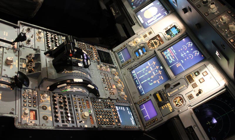 A detailed shot of an illuminated aircraft cockpit. A detailed shot of an illuminated aircraft cockpit