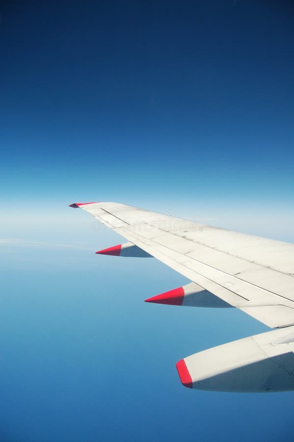 Wing of aircraft against clear blue sky. Wing of aircraft against clear blue sky