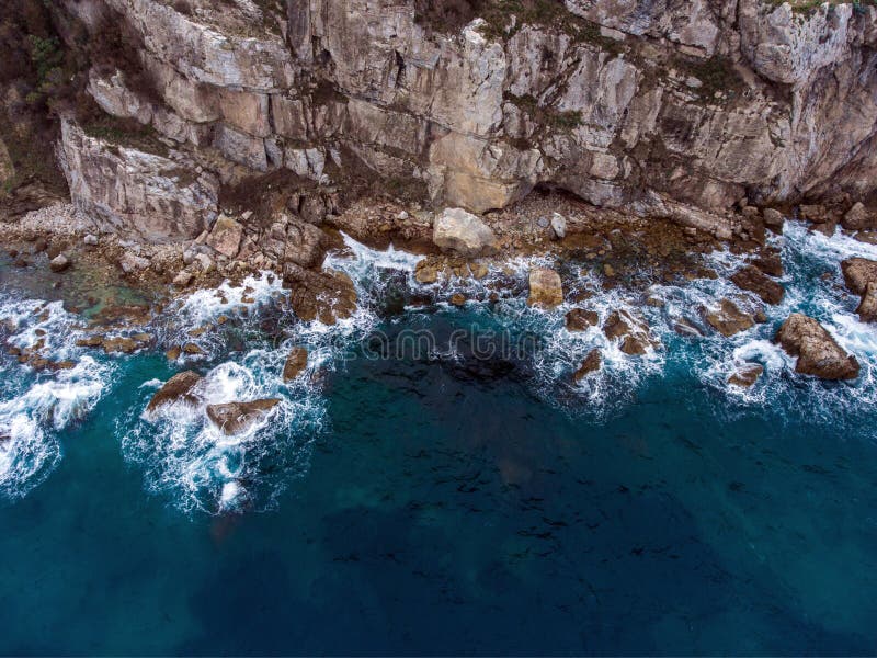 Airial view of the waves crashing on the rocks. Airial view of the waves crashing on the rocks.