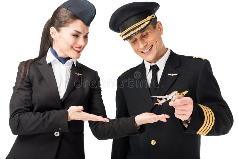 Airline crew stewardess and pilot holding toy plane stock photo Airline crew stewardess and pilot holding toy plane stock photo