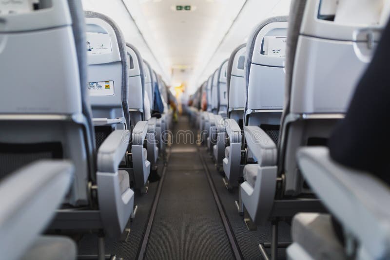 Airline passenger seats and aisle in airplane cabin