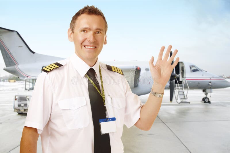 Airline pilot at the airport waving stock photos