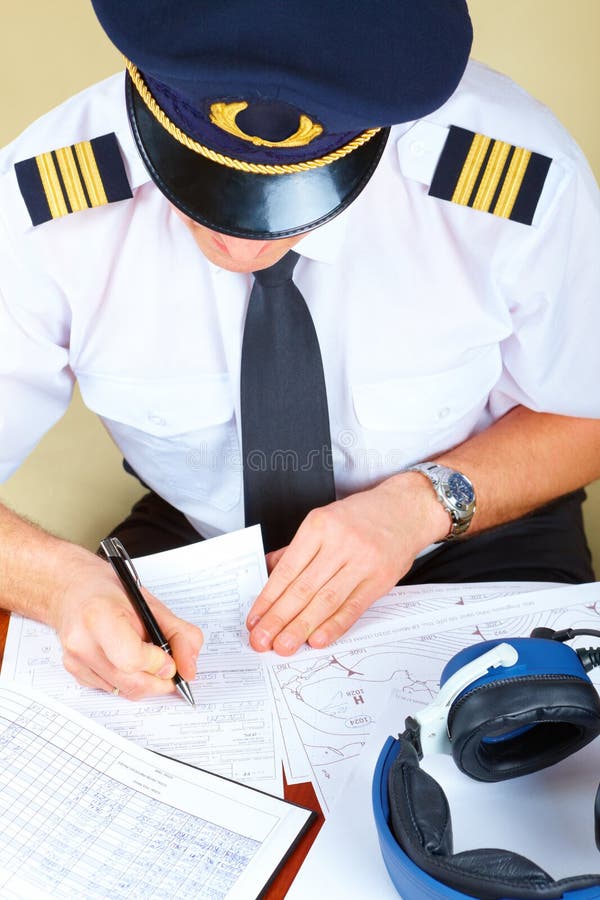 Airline pilot filling in papers royalty free stock photography