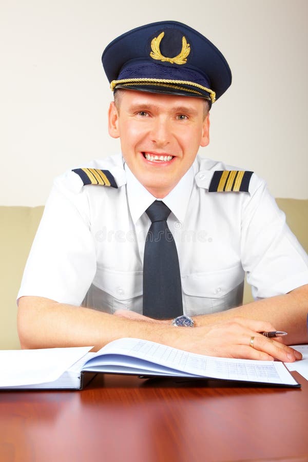 Airline pilot filling in papers in ARO stock photography