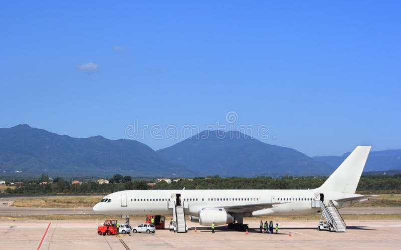 White airplane at airport, preparing for flight. White airplane at airport, preparing for flight