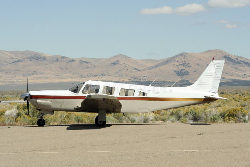 A Saratoga airplane at a desert general aviation landing field in Utah, USA. A Saratoga airplane at a desert general aviation landing field in Utah, USA.